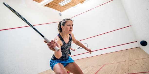 istock Young fit female squash player preparing to hit the ball 1027830328