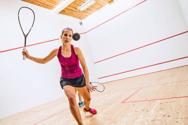 female squash player moment before hitting the ball - squash racketball sport exercising imagens e fotografias de stock