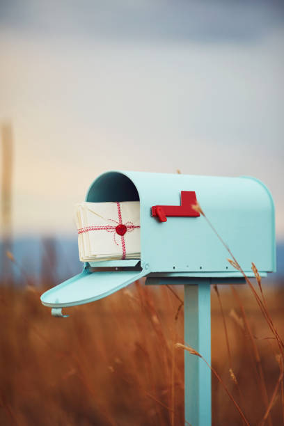 istock Pastel teal mailbox with stack of love letters 1027833642