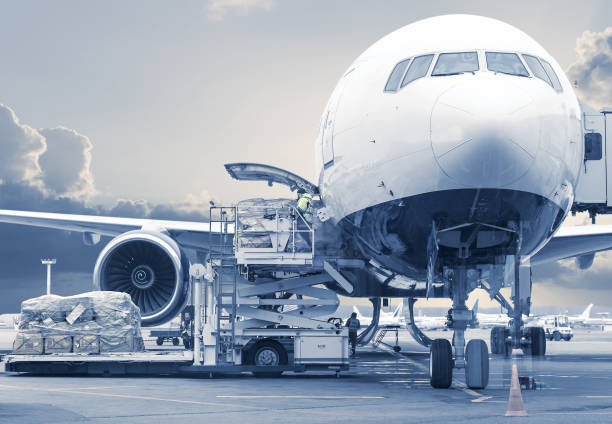 loading cargo picture in a blue toning loading cargo into the aircraft before departure cargo container stock pictures, royalty-free photos & images