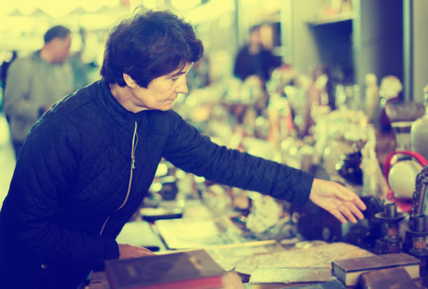istock interested elderly woman choosing interesting souvenirs at flea market 1027847764