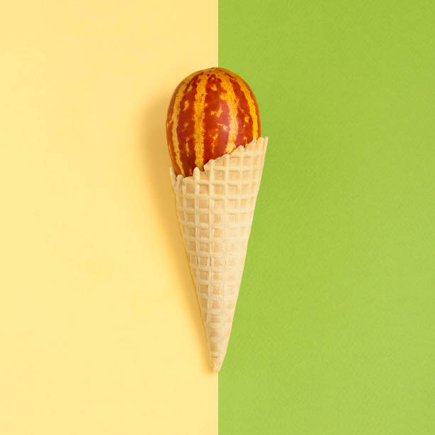 istock Mini melon with striped skin like watermelon in waffle cone 1027855200