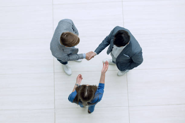istock top view.handshake business people 1027855284