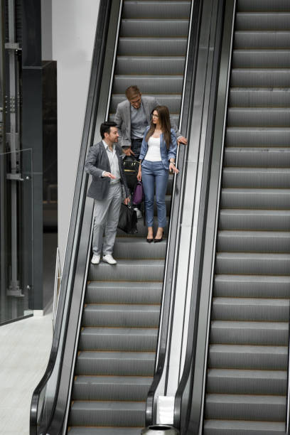 istock business people standing on the escalator 1027858486