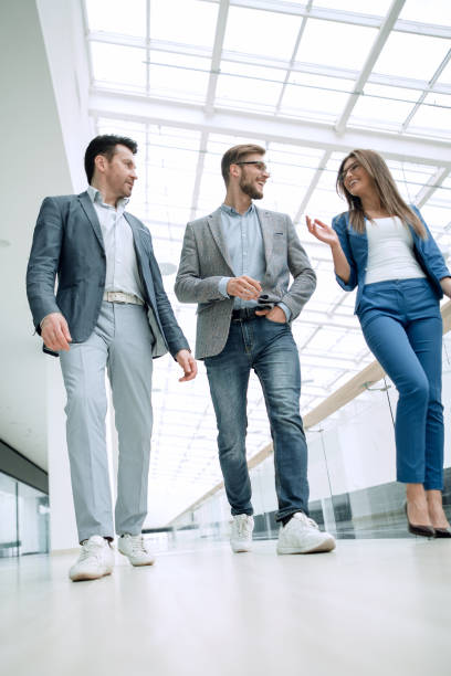 istock Business people walking in the office corridor 1027859536