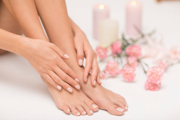 The picture of ideal done manicure and pedicure. Female hands and legs in the spa spot. cuticle photos stock pictures, royalty-free photos & images