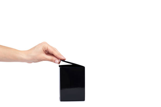 istock Black gift box with hand isolated on white background, copy space template 1027867414