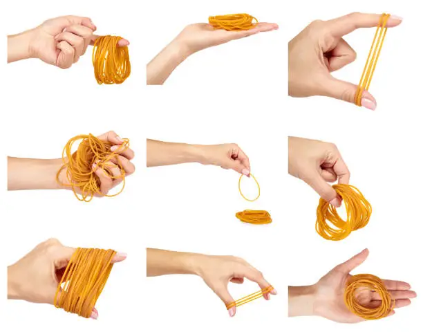 set of different Yellow rubber bands close up with hand isolated on white background.