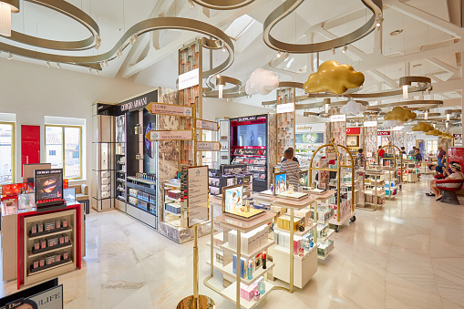 Venice, Italy - August 15, 2017: Fondaco dei Tedeschi, luxury department store interior, cosmetics and perfums area with people