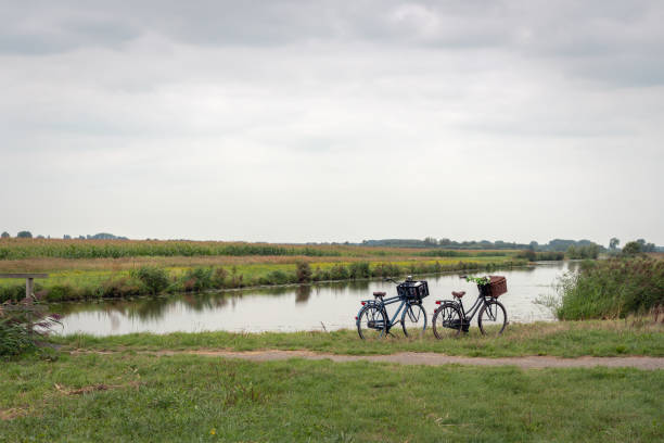 istock Dutch polder landscape with a stream and two bicycles 1027869442