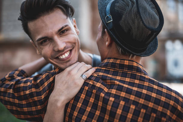 istock Positive comrade hugging male on the street 1027875394
