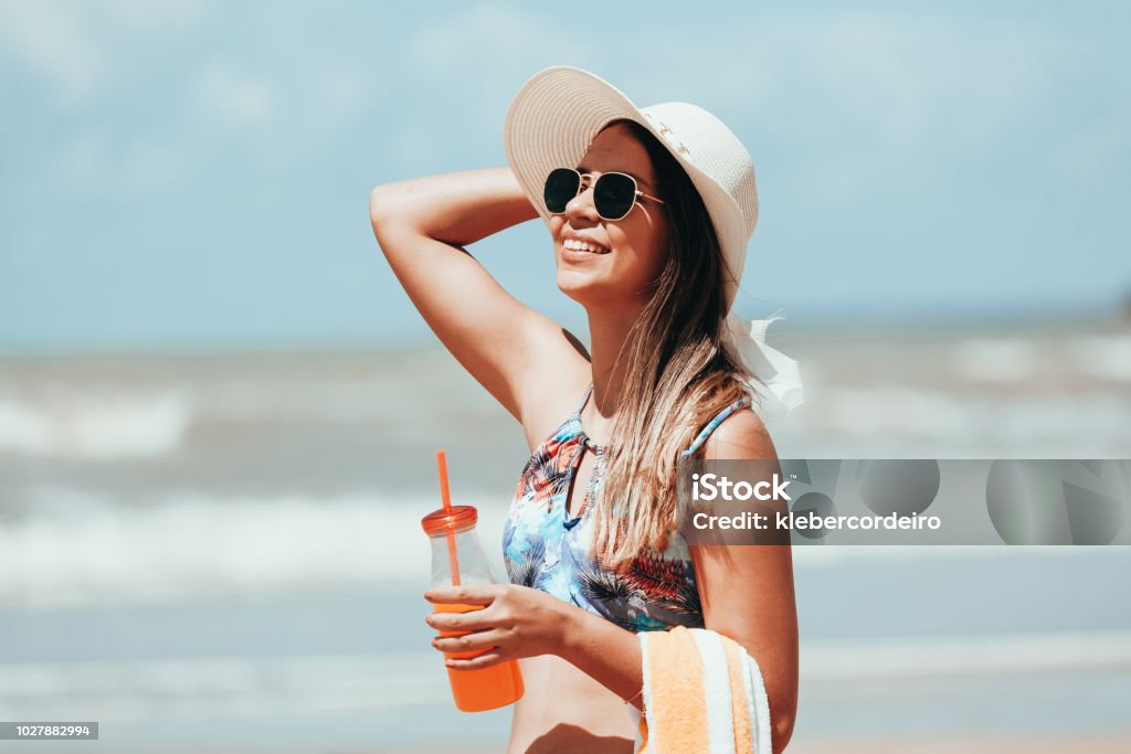 Fashion woman drinking cocktail on the beach Women Stock Photo