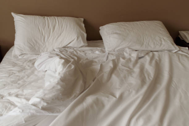 istock Unmade white mattress and pillows on a bed 1027893354