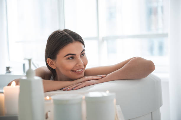 istock Cheerful woman resting in bathroom in room 1027896316