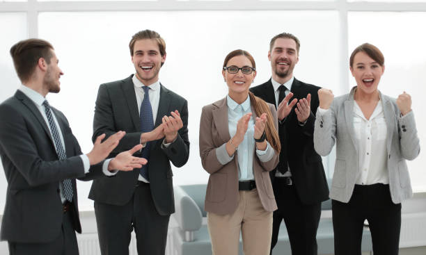 istock smiling business team applauds their success 1027909582