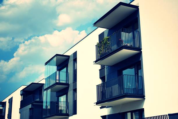 istock Modern apartment building exterior. Retro colors stylization 1027911818
