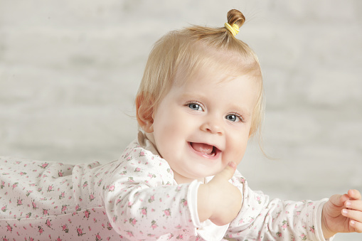 Portrait of a cute baby girl smiling cheerfully