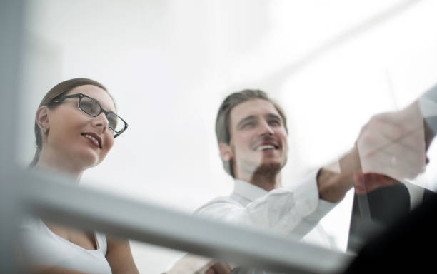 istock view from behind glass.handshake business people 1027921448