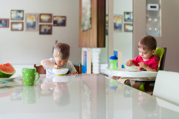 istock Down's Syndrome sweet boy eating breakfast with his brother 1027929542