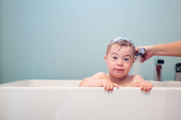 istock Down's Syndrome sweet boy in the bath. 1027932698