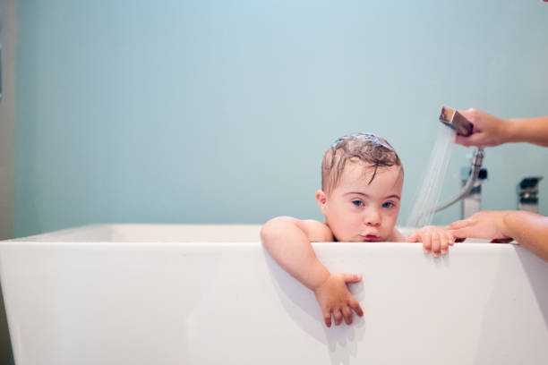 istock Down's Syndrome sweet boy in the bath. 1027932850