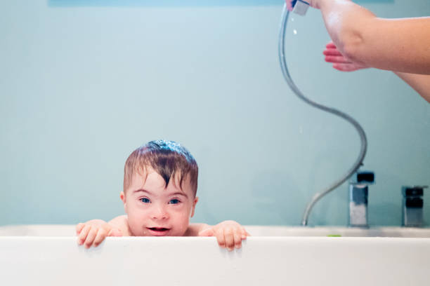 istock Down's Syndrome sweet boy in the bath. 1027932910