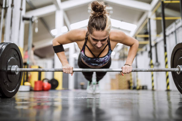 istock Athletic Woman Doing Push Ups With Weights 1027938368