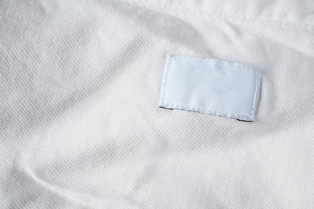 istock White blank laundry care clothes label on cotton shirt 1027941230