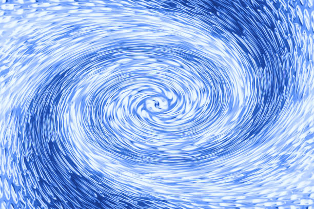 istock Space matter revolves around a spiral wormhole of cobalt color. Fantastic background image of asymmetric vortex tunnel in center of shot in blue. 1027953350