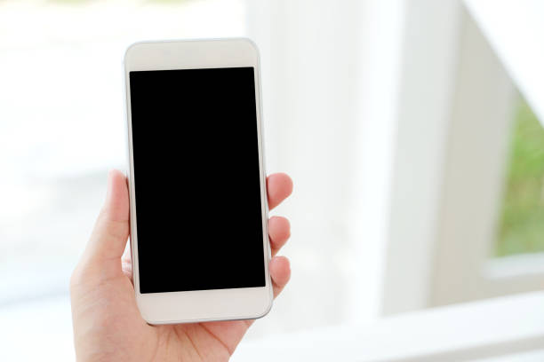 istock Man hand holding black smart phone with blank screen on background for mock up, template, technology and lifestyle 1027956122