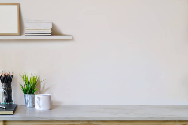 istock Workspace and copy space, wood table with plant, coffee cup, mockup poster and stuff. 1027968834