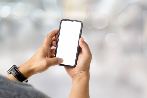 istock Businessman using a mobile phone. Blank screen smart phone for graphic display montage. 1027969012