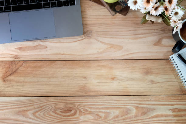 istock Office workspace table with laptop , notebook and stationary on brown wood desk. Workplace and copy space top view shot. 1027969018