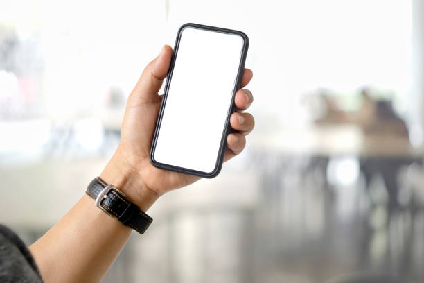 istock Close up of a man using blank screen mobile smart phone over blurred bokeh background. 1027969136