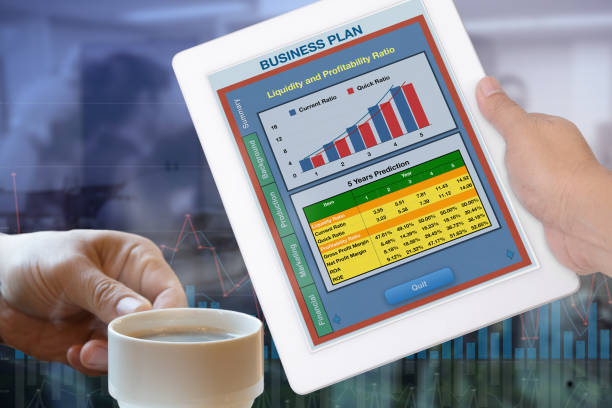 istock Business plan showing on digital tablet in someone hand. 1027978254
