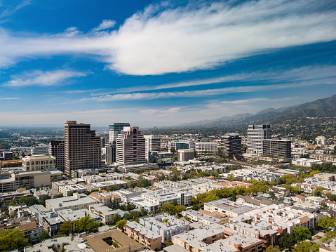 Downtown Glendale, California skyline, aerial view with condo/apartment buildings in the foreground, and with the Verdugo Mountains and other parts of the San Fernando Valley in the distance.  Glendale is a part of the Greater Los Angeles metropolitan area.
