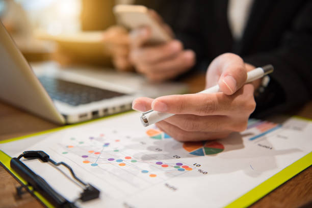 istock Businessman making presentation on office table with smart phone and laptop computer and graph business with social network 1027997002