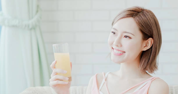 istock woman drink juice 1028008674