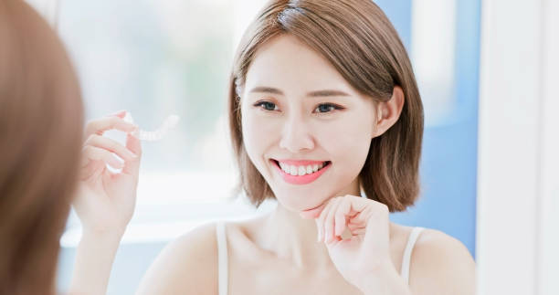 istock woman take invisible braces 1028008796