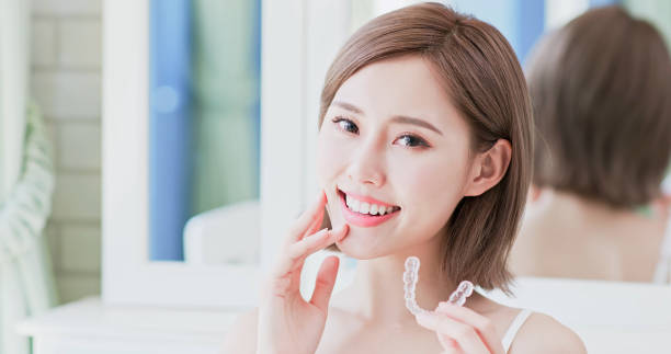 istock woman take invisible braces 1028008804