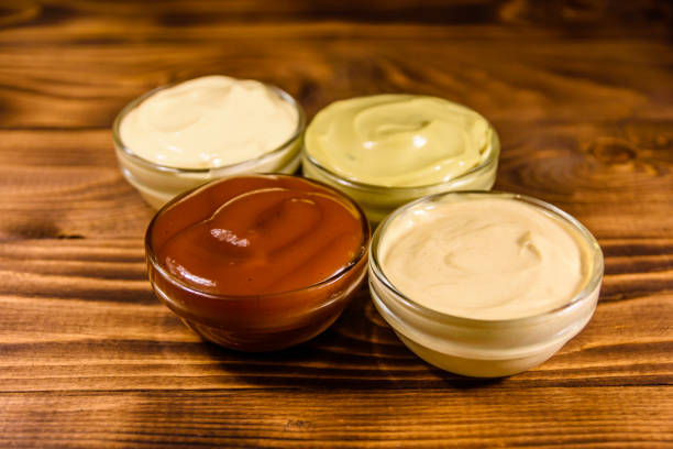 istock Different sauces in glass bowls on wooden table 1028012050