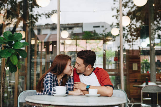 istock Lovely asian couple having coffee 1028035142