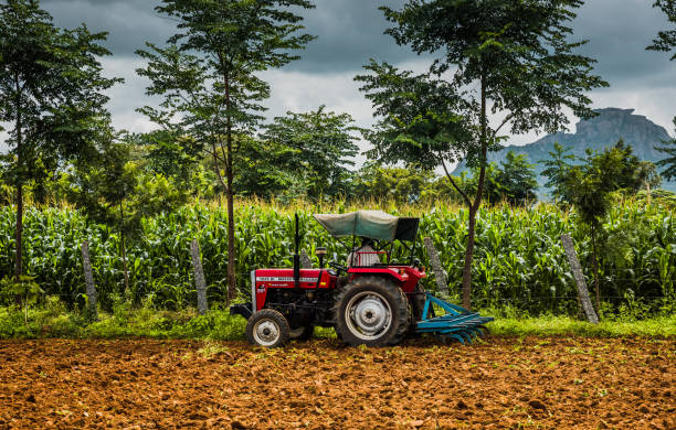 Bangalore, Karnataka/India - August 21, 2018: Farmer Harrowing Agricultural Field By A Large Harrowing Machine