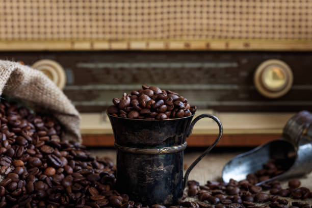 istock Coffee beans infront of an old radio 1028045078