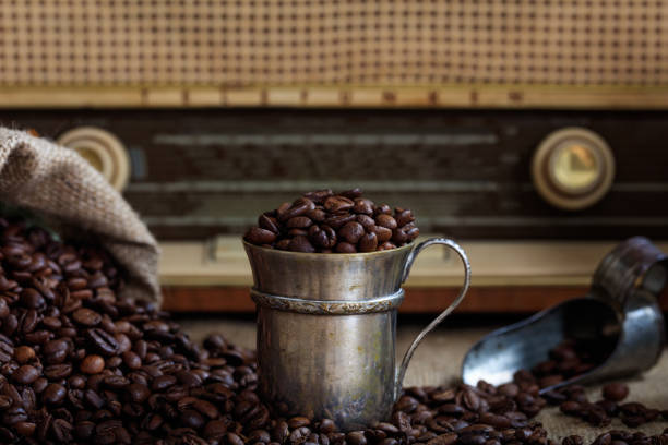 istock Coffee beans infront of an old radio 1028045080