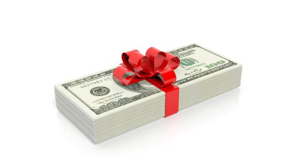 istock Dollar banknotes of 100 stack with red ribbon, isolated on white background 1028053062
