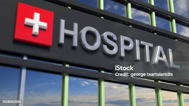 Hospital Building Sign Closeup With Sky Reflecting In The Glass Stock Photo - Download Image Now