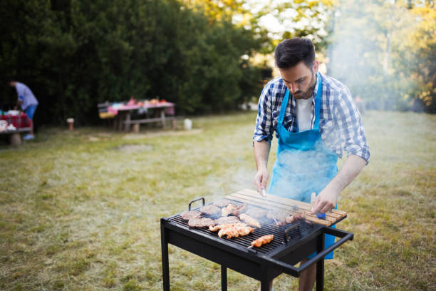 istock Handsome male preparing barbecue 1028053128