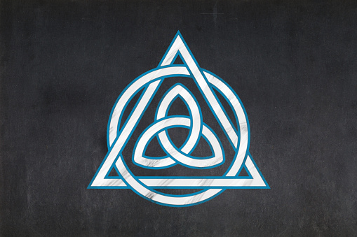 Blackboard with a the Triquetra (inside of an interlaced Christian Trinitarian symbol) drawn in the middle.