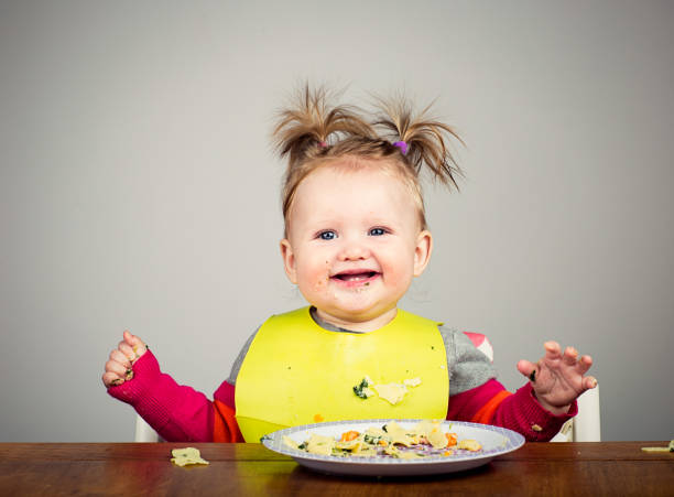 istock Funny 9 month old eating pasta 1028056508